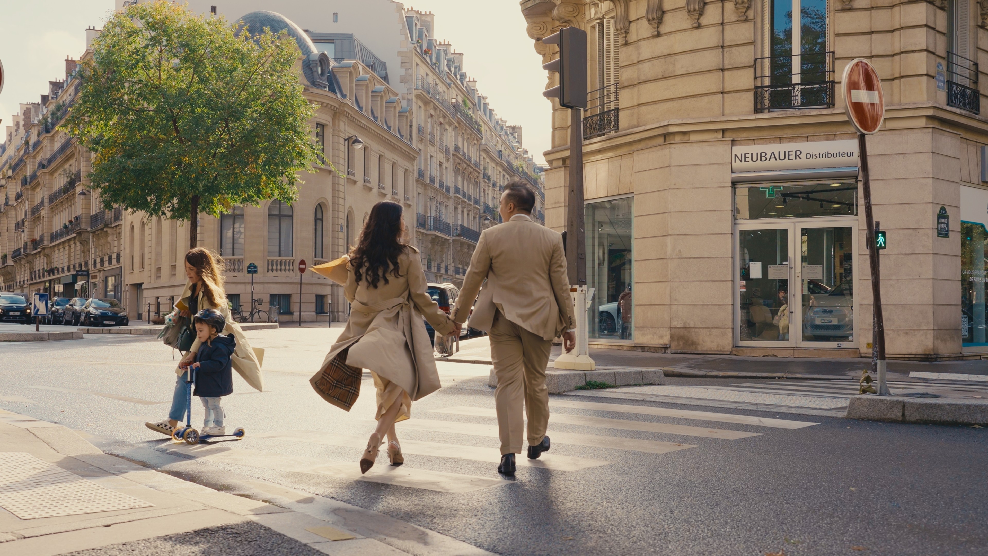 Couple walking a Paris street in daylight