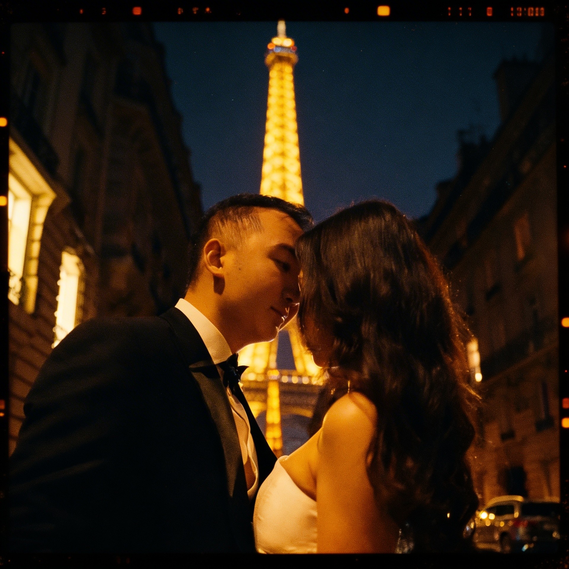 Couple beside the Eiffel Tower at night